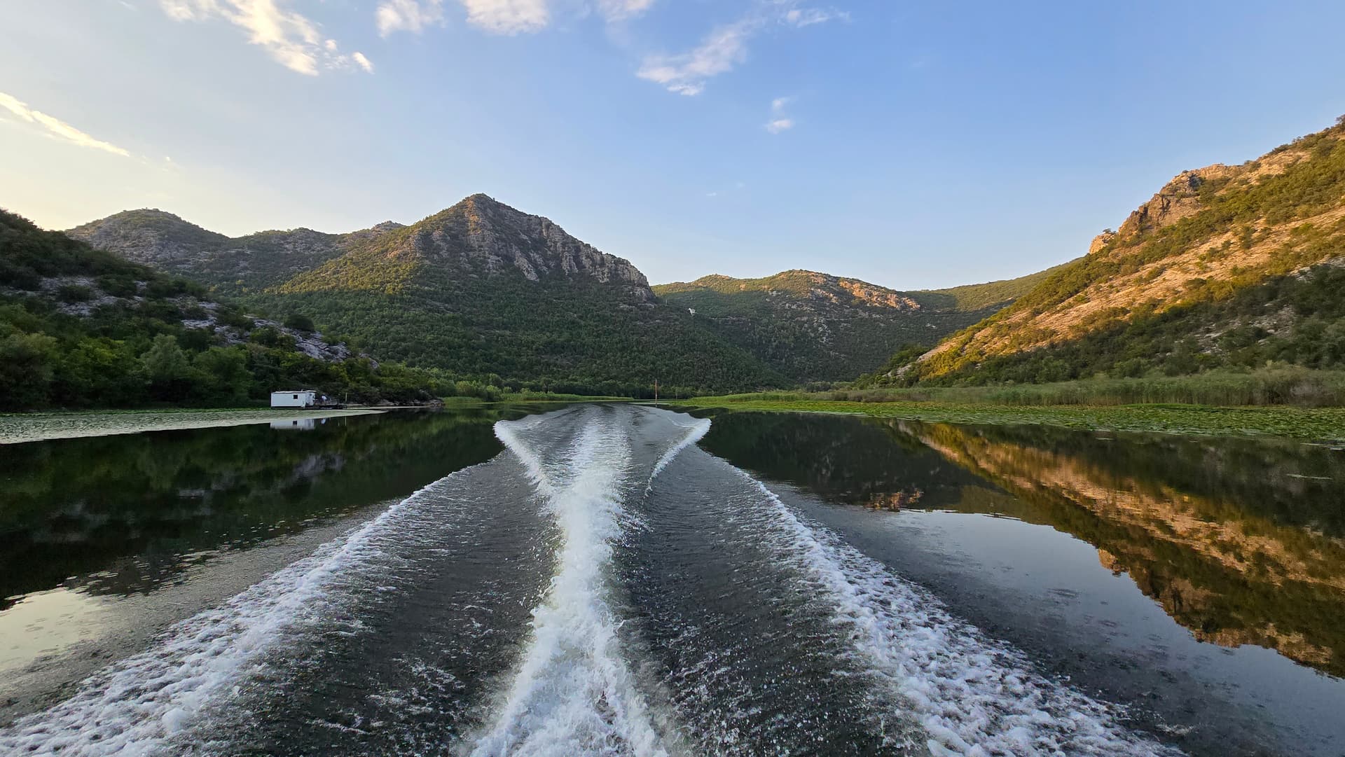 Boat wake through a mountain canyon channel on Skadar Lake